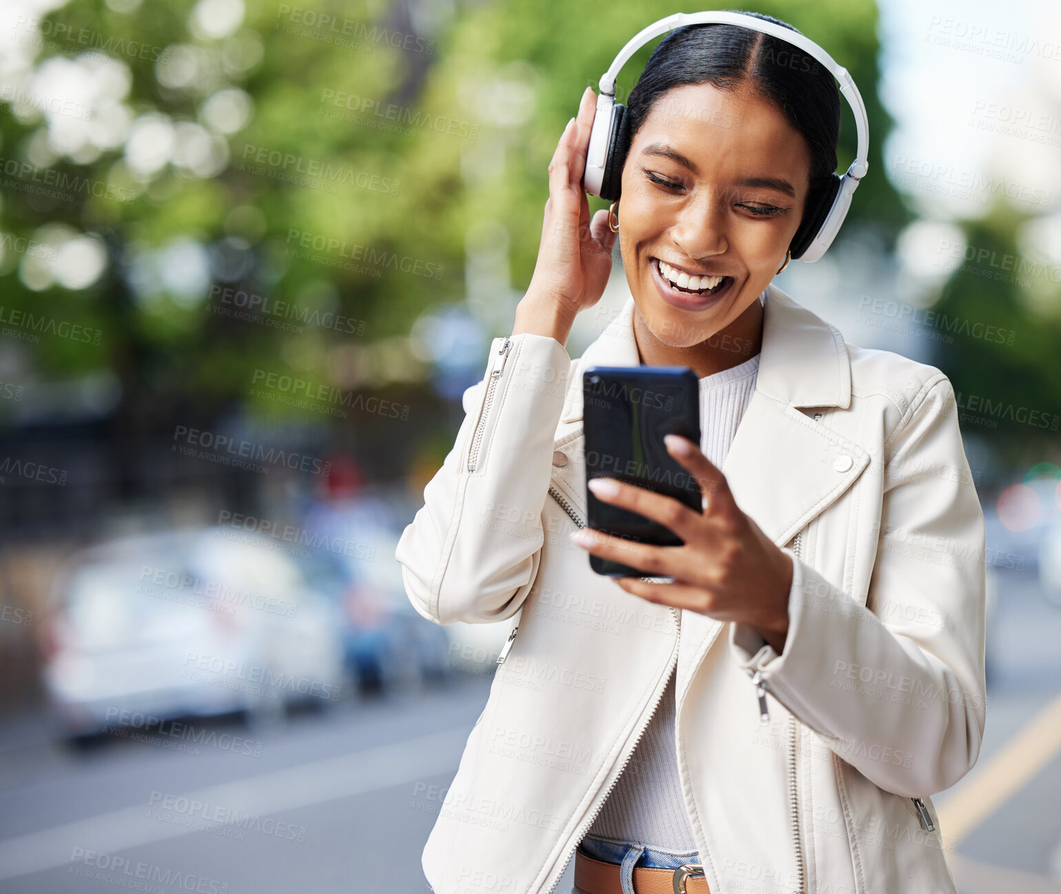 Buy stock photo Happy city girl with phone and headphones listening to music, podcast or streaming a online subscription service movie. Black woman watching funny web comedy, internet meme or social media app video 