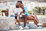 Outdoor park, smartphone and couple watching online video content, funny meme or social media post together on bench. Happy, relax and in love man and woman browsing internet on summer weekend break