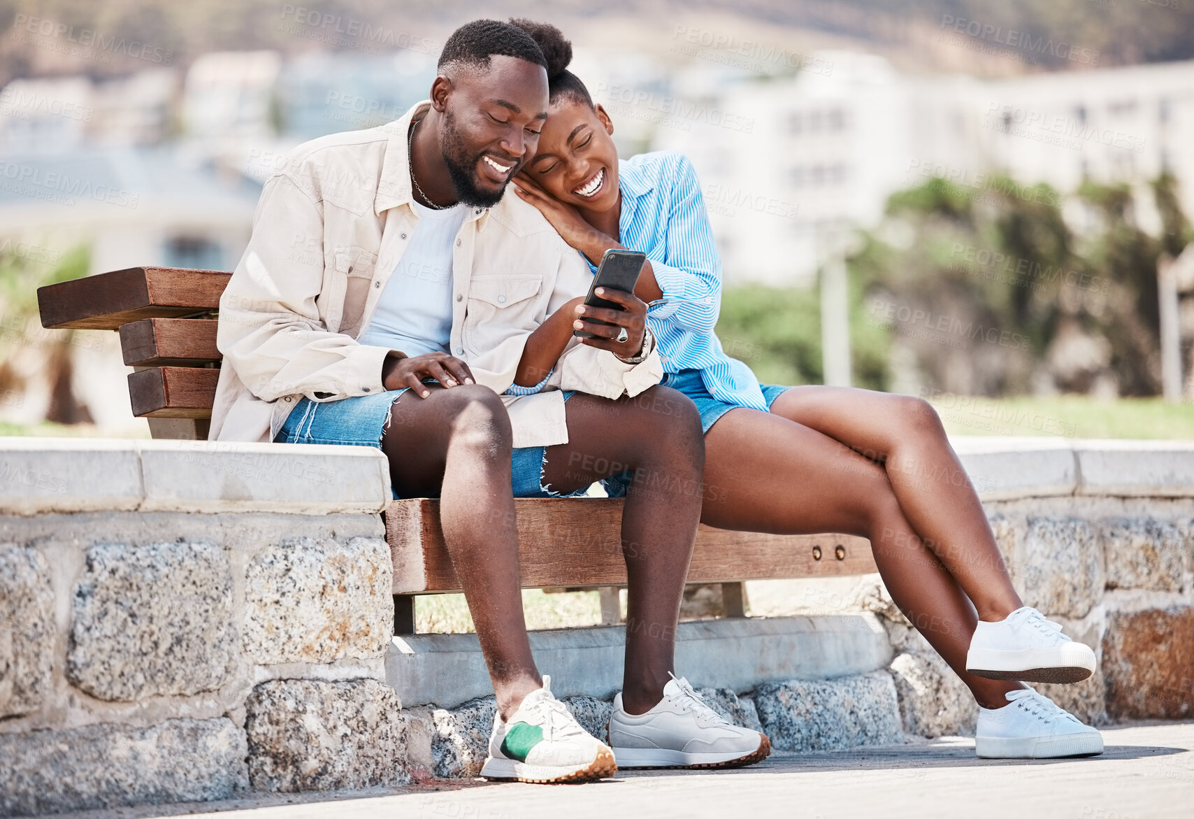 Buy stock photo Outdoor park, smartphone and couple watching online video content, funny meme or social media post together on bench. Happy, relax and in love man and woman browsing internet on summer weekend break