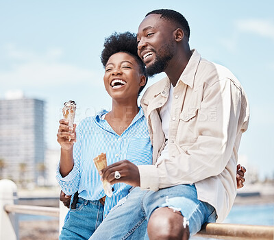 Buy stock photo Happy couple at the beach eating an ice cream cone while on a date in nature while on spring vacation. Black man and woman talking and laughing while hugging and having dessert on holiday by seaside.