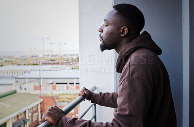Buy stock photo Depressed, sad and thinking man with mental health problem on balcony, planning idea while in apartment with anxiety and burnout from depression. Fail, decision and African person think at house