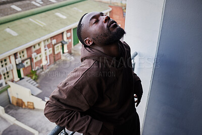 Buy stock photo Depression, mental health and anxiety for sad man suffering from life problem stress on balcony of home apartment. Depressed black person face with negative mindset, pain and frustrated over failure 