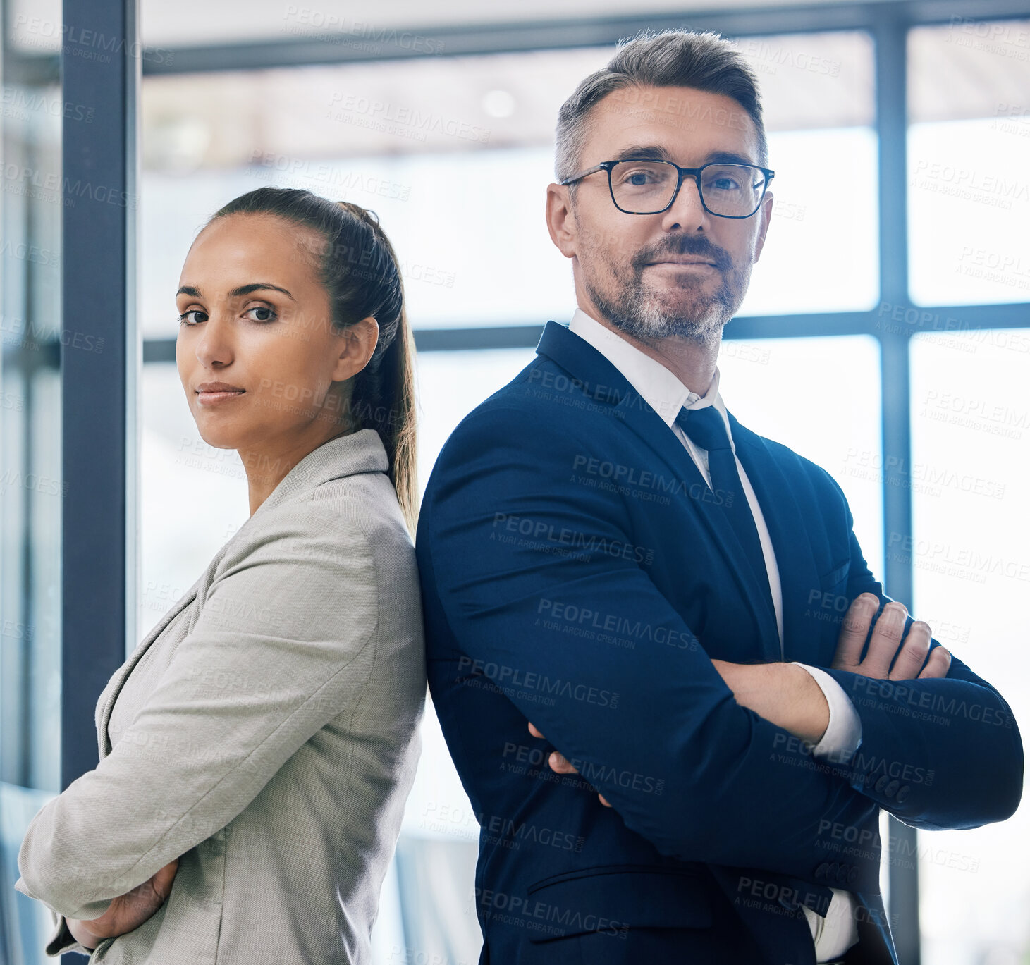 Buy stock photo Partnership, arms crossed and teamwork with two business people standing together in corporate office building. Success, motivation and vision with employees in innovation or management company