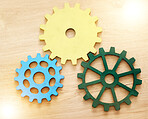 Collaboration, engineering and construction concept with industrial gears, mechanics and cogs on a table or desk in an office. Teamwork, synergy and industry with the idea of building or design