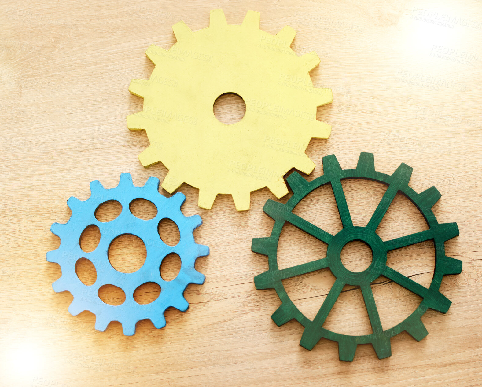 Buy stock photo Collaboration, engineering and construction concept with industrial gears, mechanics and cogs on a table or desk in an office. Teamwork, synergy and industry with the idea of building or design