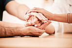 Support, care and family holding hands together at table to show empathy, love and hope. Closeup of connection, trust and friendship in community rehab group showing compassion and gratitude.