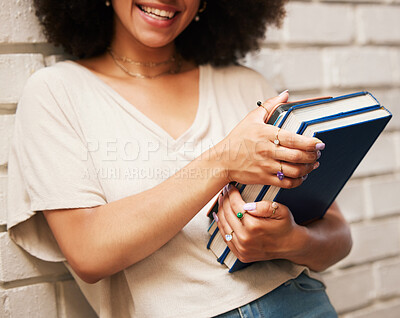 Happy student with books on university campus, scholarship for education at school and smile for learning at library. African girl studying law, doing research and motivation for future career