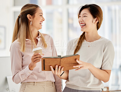 Buy stock photo Women employee smile and laugh while planning a strategy in a marketing and advertising office. Diversity, collaboration and teamwork as worker support and schedule in a notebook at startup company