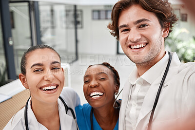 Buy stock photo Healthcare, hospital and doctors taking selfie, bonding while working together and having fun. Medical intern posing for a picture, smiling and laughing, enjoying diverse friendship at the workplace