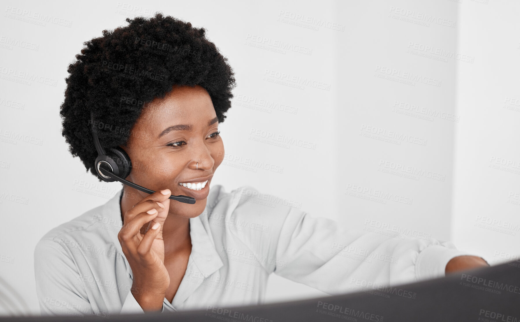 Buy stock photo Call center consultant in communication online on computer, consulting with people on the internet and support in customer care job at telemarketing company. Happy African receptionist on phone call