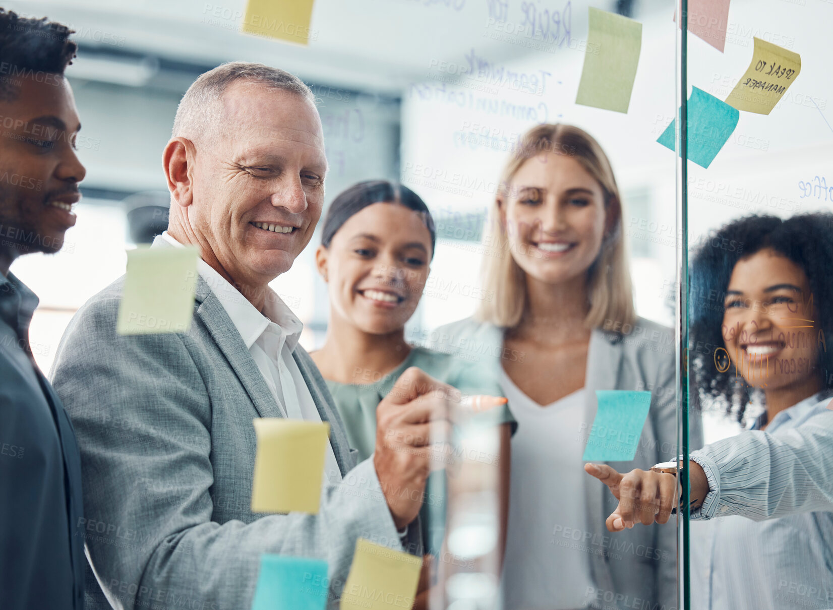 Buy stock photo Business people planning with sticky note in meeting, writing advertising strategy on glass board and team collaboration for creative idea at work. Marketing workers working on design partnership