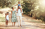Happy black family bonding on an outdoor work in a park, loving and having fun together. African American parents enjoying fresh air and an active walk with their children, playful, cheerful and free