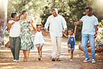 Black family, hiking or bond with children, parents or grandparents walking in remote nature forest and countryside. Happy mother, father or senior holding hands with girls and skipping in tree park 