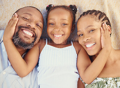 Buy stock photo Love, care and happy black family bonding, relax and rest together at home from above. Portrait of smile parents enjoying time with their child, showing affection and being loving with their daughter