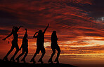 Sunset, silhouette and women friends out on an adventure or travel for fun with roller skates watching the horizon view with orange or red sky. Freedom, scenery and beauty of nature and friendship
