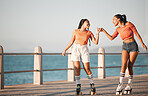 Girl, women or friends roller skate on sea, water or ocean sidewalk together for fun travel and relax adventure ride. Fist bump, friendship and journey for fitness, exercise and skate training cardio