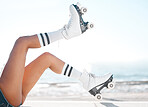 Roller skates, travel and summer vacation and beach fun with woman enjoying hobby, relax and freedom while skating. Legs and retro footwear of a fit female skater out for active adventure by the sea