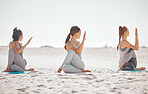 Zen, heath and yoga group meditation on a beach with women training and meditating together. Athletic friends exercise, practice posture and balance yoga pose with zen, peaceful energy in nature