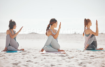 Buy stock photo Zen, heath and yoga group meditation on a beach with women training and meditating together. Athletic friends exercise, practice posture and balance yoga pose with zen, peaceful energy in nature