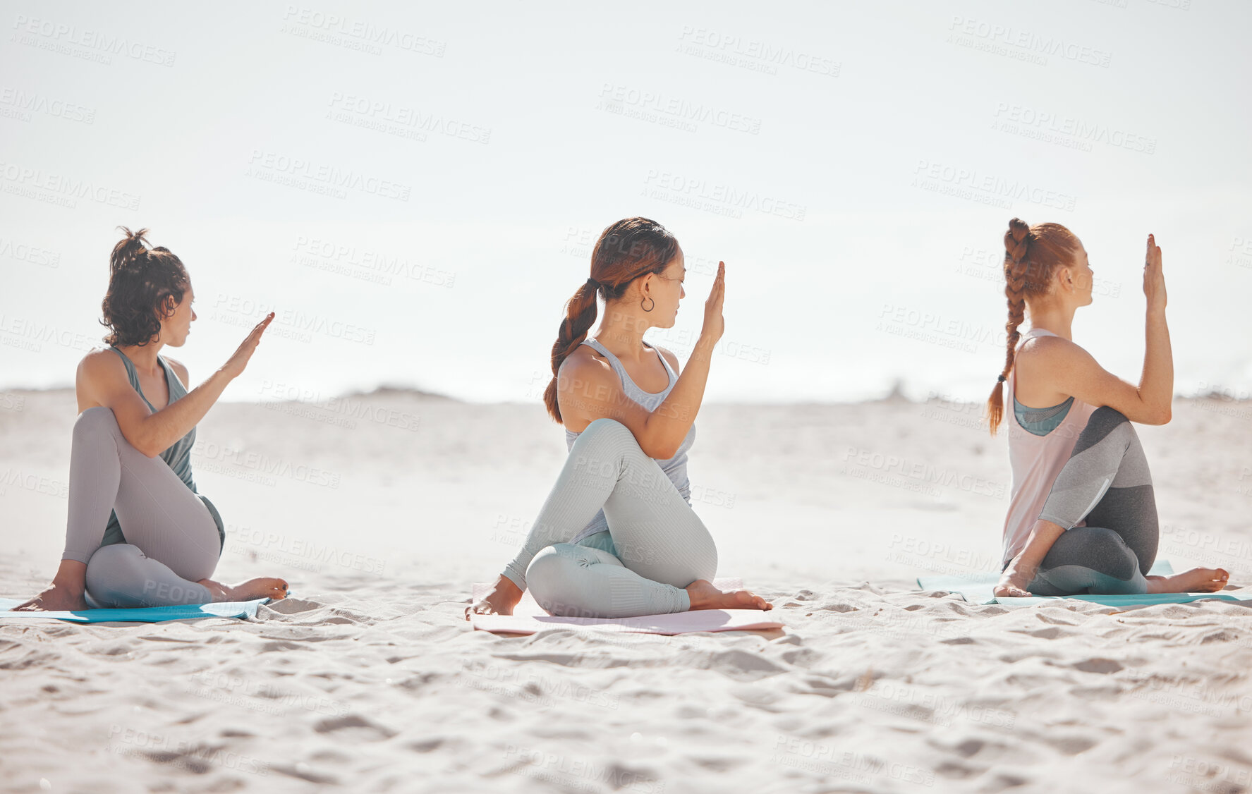 Buy stock photo Zen, heath and yoga group meditation on a beach with women training and meditating together. Athletic friends exercise, practice posture and balance yoga pose with zen, peaceful energy in nature