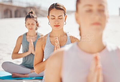 Buy stock photo Women friends meditation while training yoga exercise on the beach. Young zen spiritual female athlete workout outdoor. Faith, inner peace, balance and getting healthy focus on a fitness lifestyle