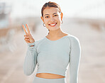 Peace sign hand, fitness woman or motivation for health and wellness goals in exercise, training or workout. Portrait of smile, happy and cool personal trainer, runner or sports athlete on background