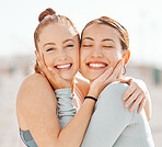 Young women, with hands on face hug and smile in sunshine together on summer vacation. Couple of friends with happy expression, touch love and laugh outside in warm sunlight on holiday together. 