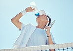 Sport, fitness and tennis man drinking water after workout, training game or health exercise on court. Wellness, sports and drink liquid from bottle after cardio, run or exercising  
