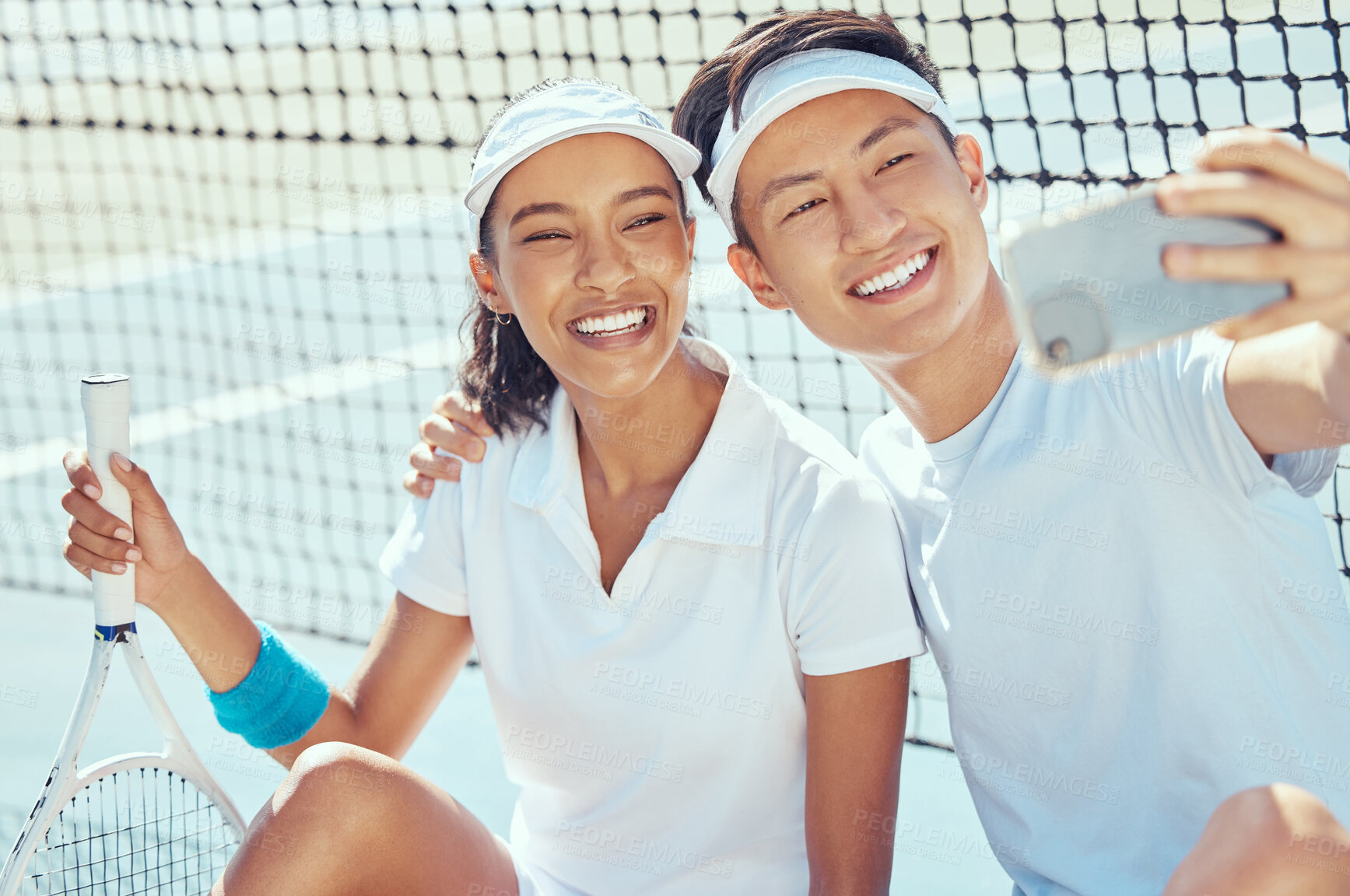 Buy stock photo Fitness, phone and couple in a selfie on a tennis court in summer before training, exercise and workout together. Happy, smile and young woman with healthy Asian boyfriend posing for social media