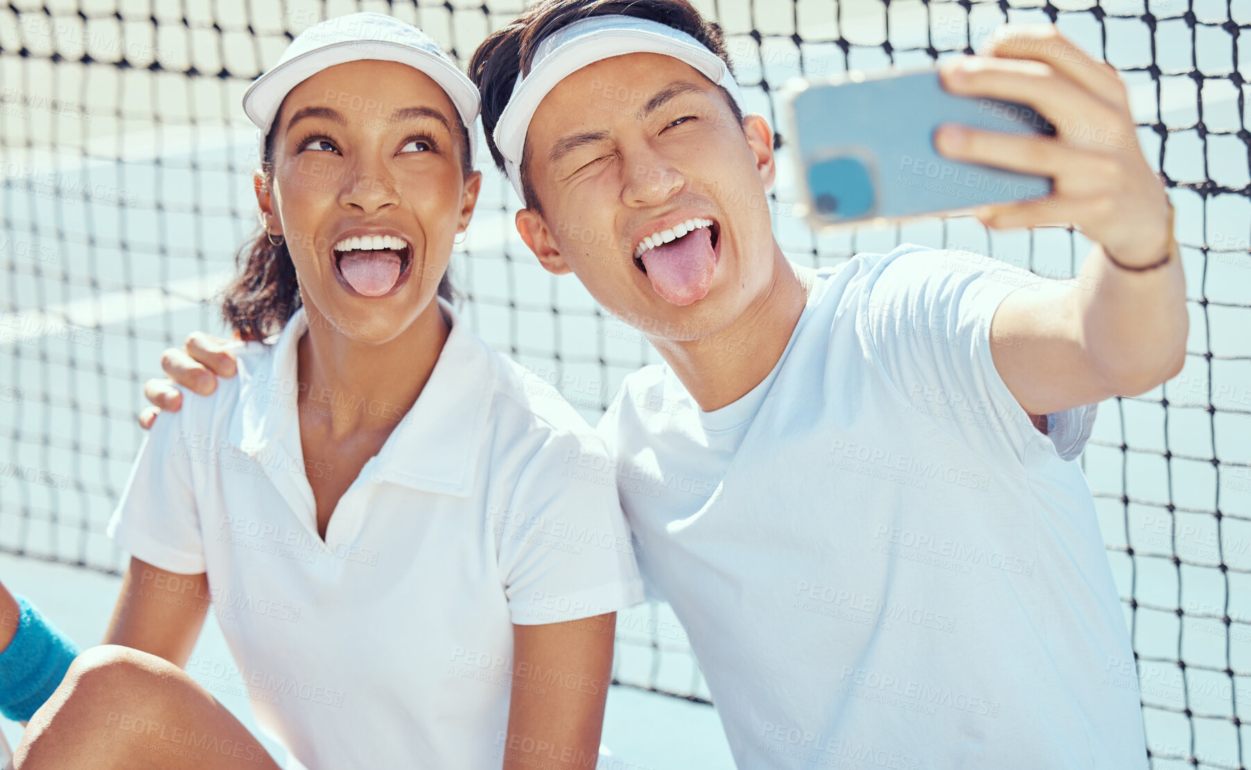 Buy stock photo Tennis team taking funny selfie with phone, comic sports people being crazy training for sport competition on court and collaboration at fitness event. Happy, smile and relax athlete taking photo