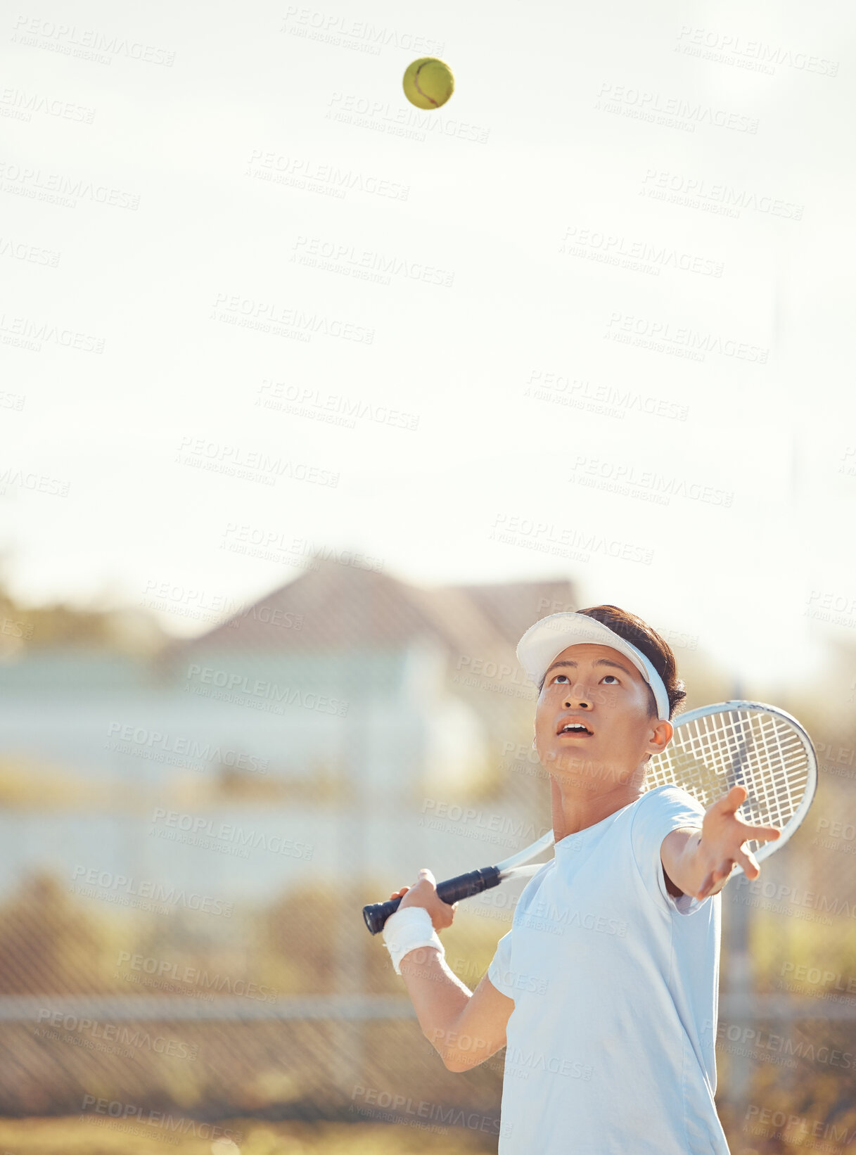 Buy stock photo Tennis ball, serving and competitive sports man training or playing a match of game with a racket on an outdoor court. Serious, active and asian man training for competition, fitness and wellness