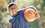 Portrait, basketball and happy black boy ready to train outside for fitness, health and wellness. Sports, childhood and learning with a child playing a sport outdoors for practice, fun or recreation
