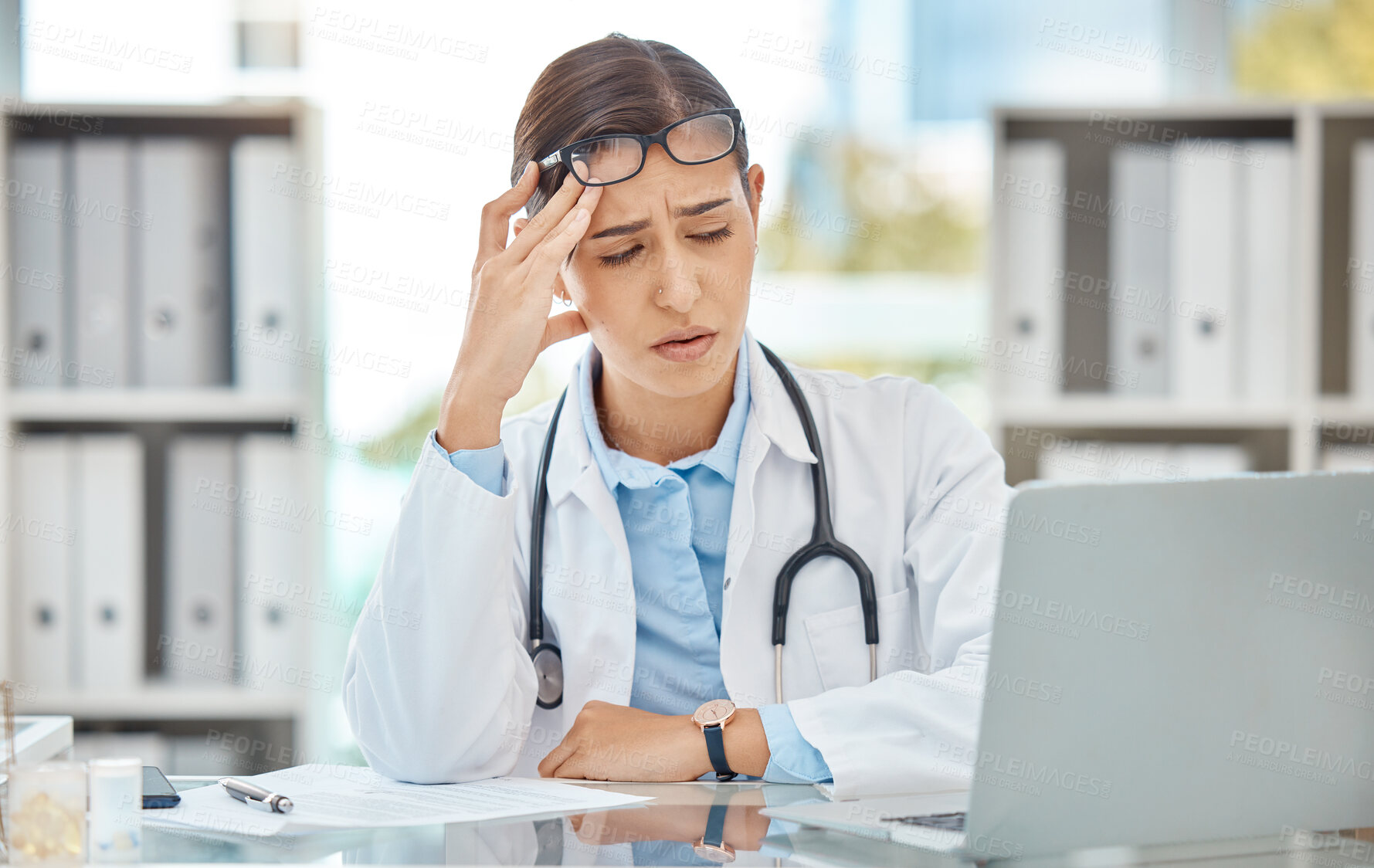 Buy stock photo Headache stress, doctor burnout and sad nurse working on laptop in work office at hospital, tired from consulting in healthcare and anxiety from medical surgery. Worker with depression at clinic