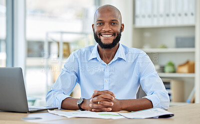 Buy stock photo Portrait of a happy African businessman sitting at his desk in his modern corporate office. Professional black manager working or planning a company project with a laptop and paperwork at a table.