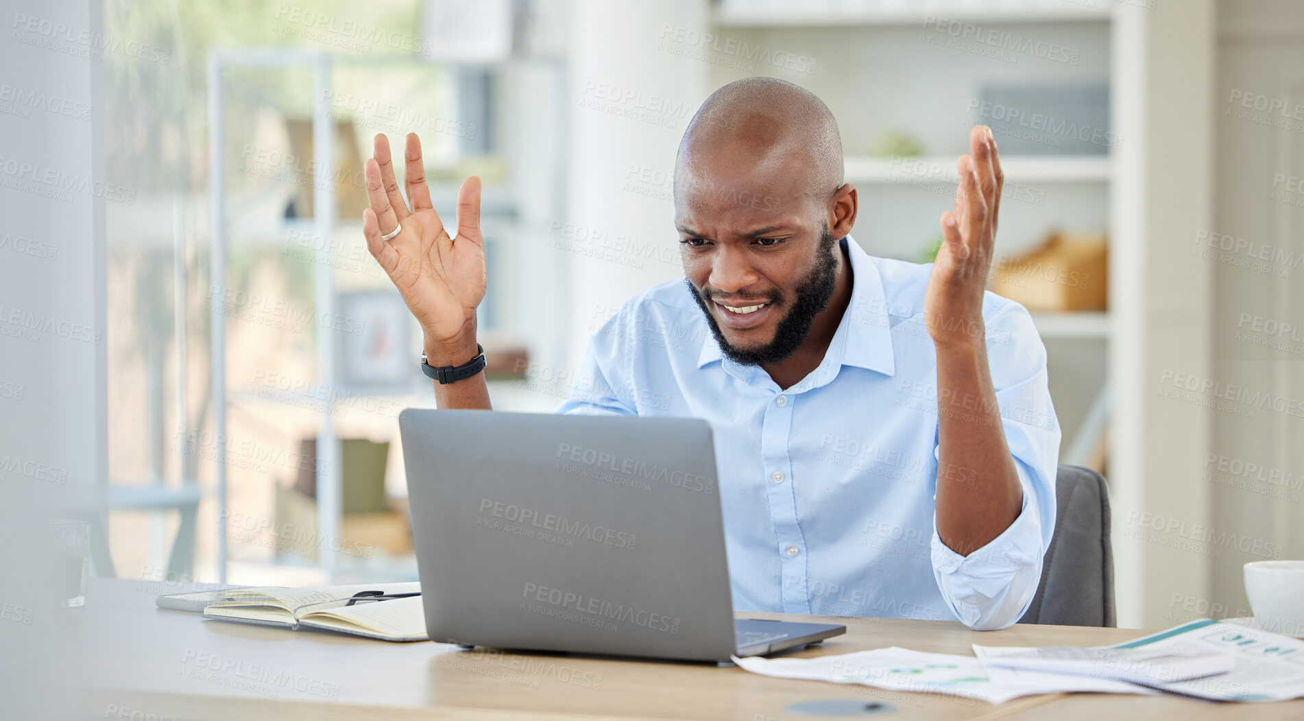 Buy stock photo Stressed, upset and frustrated black businessman on a work conference call on a laptop. Angry, African and corporate manager with company documents on a broken computer at his desk in a modern office