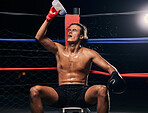 Boxing athlete with water bottle and tired after workout, training or exercise in a ring. Professional boxer rest and hydrate after fitness mma, muay thai or fighting practice, match and fight