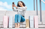 Selfie, shopping and female influencer and blogger sitting outside with bags after a spending spree while on city stairs. Happy, consumer or customer live streaming fashion sale and promotion offer