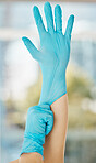 Compliance, safety and hand glove during covid pandemic by female cleaner getting ready to clean house or apartment. Domestic worker practice corona rules and hygiene before housework and sanitizing