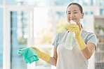 Housekeeping, products and happy woman cleaning the windows with detergent, cloth and gloves. Maid, cleaner or domestic worker washing the dust and bacteria off the glass in an apartment building.