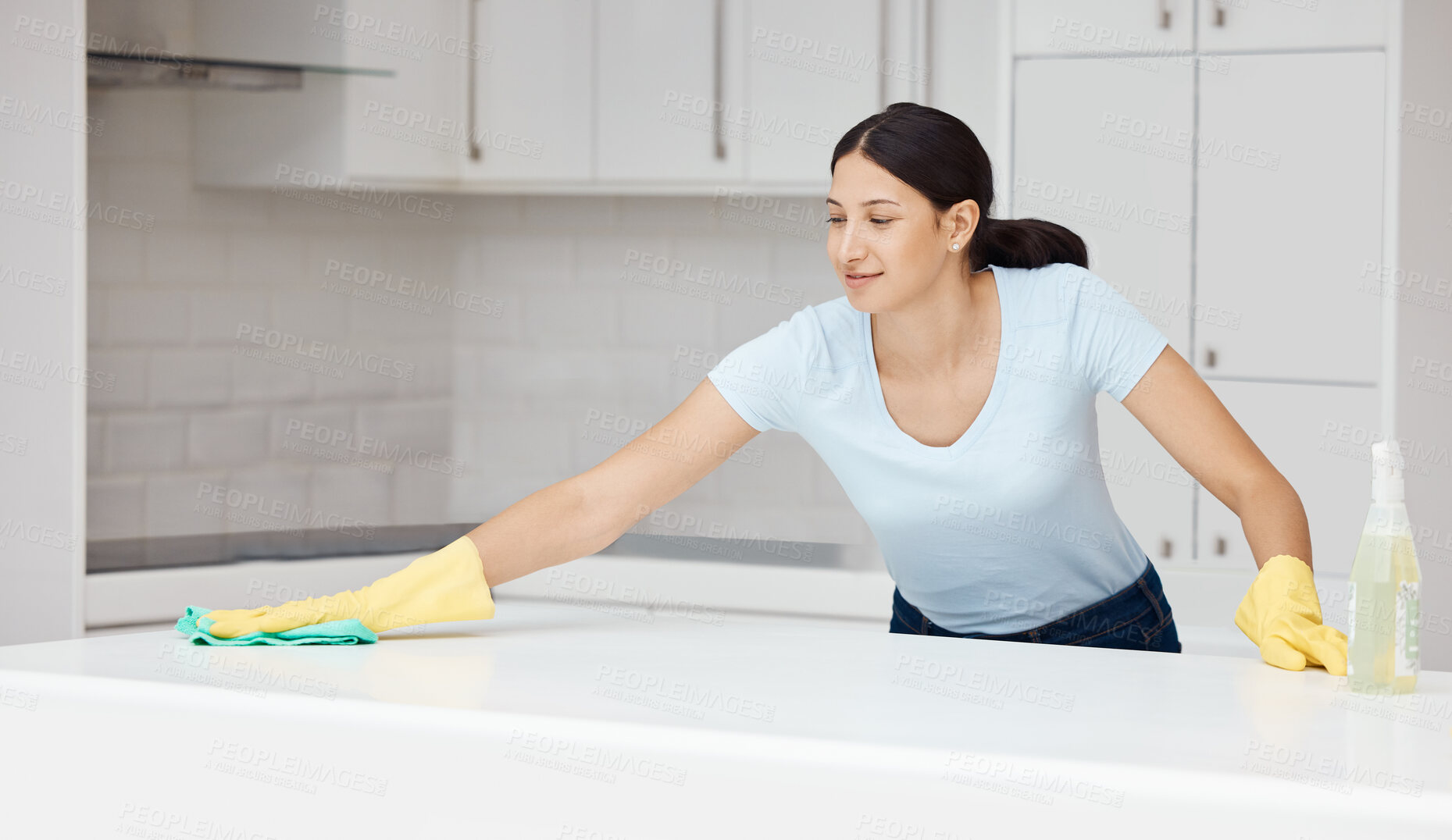 Buy stock photo Woman, wipe or cleaning kitchen counter with housekeeping spray bottle product for home cleaner service, maid or worker. Happy smile, healthcare fabric cloth in bacteria spring clean in interior room