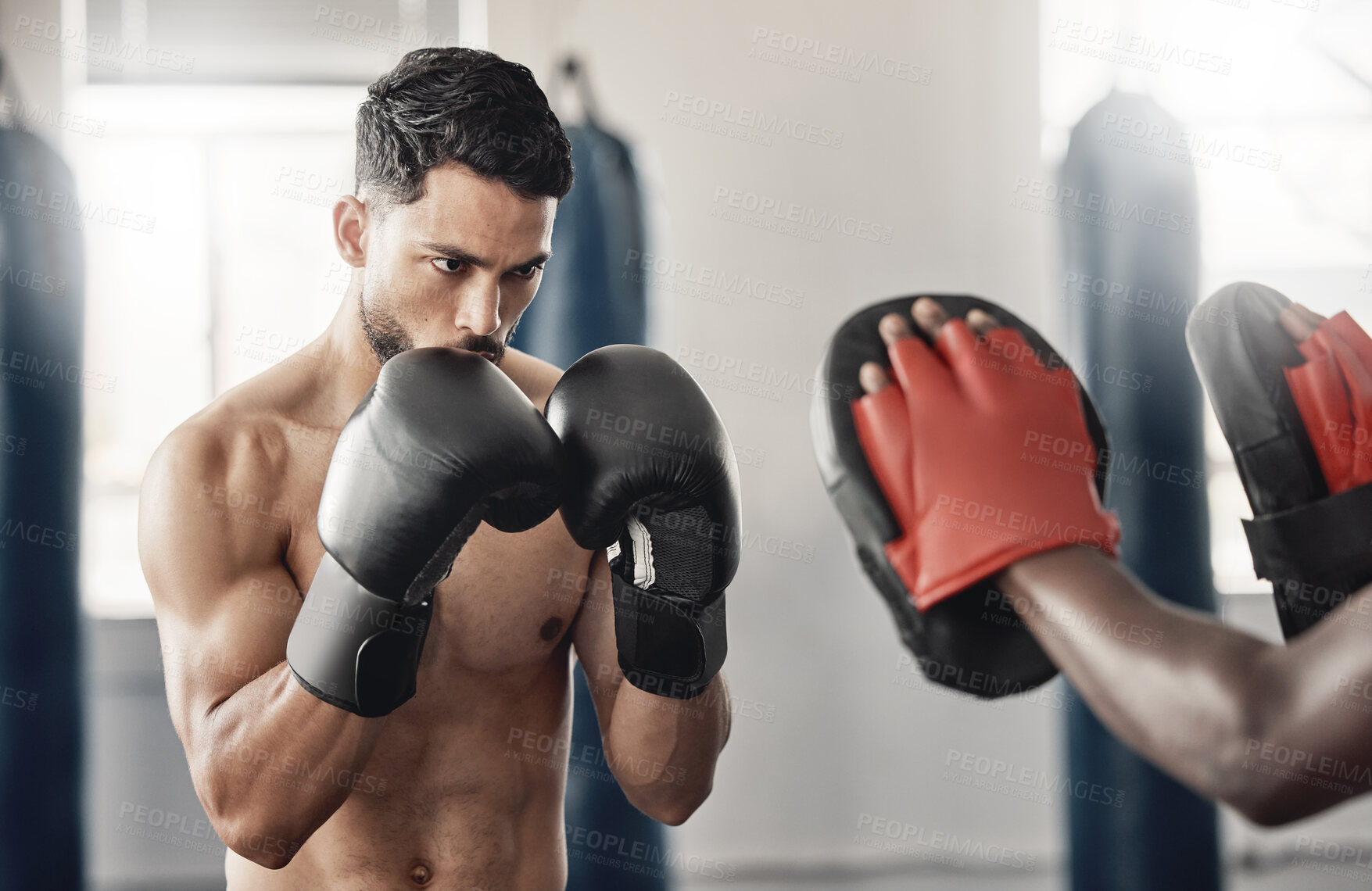 Buy stock photo Boxing gym, fighting pad and man training with athlete coach for a fitness cardio exercise session. Strength, focus and fighter workout for punch technique with professional sports equipment.