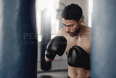 Buy stock photo Boxing man, punching bag and strong power, focus mma and fighter training challenge in gym club, exercise and combat sports. Fitness champion, healthy warrior athlete and pro boxer gloves hit impact