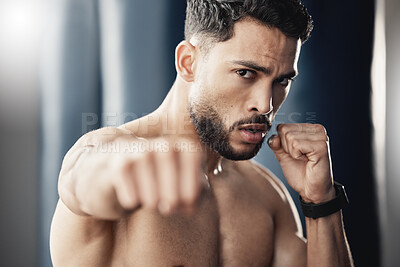 Buy stock photo Fist, hand and boxing portrait of man, athlete and strong boxer training, exercise and workout in a gym or fitness club. Motivation, health and young fighting professional working on sports endurance