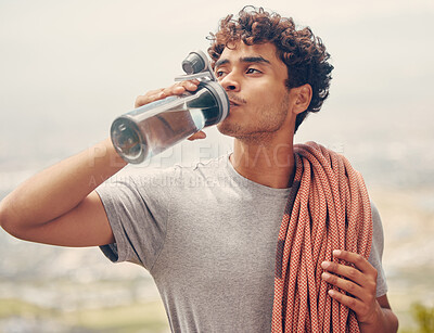 Buy stock photo Sports man drinking water, hiking or rope rock mountain climbing adventure, workout or exercise outdoor. Wellness fitness and extreme sport climber with health, relax and refreshing liquid on break.