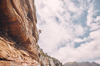 Buy stock photo Rock, sport and mountain adventure man climber free climbing rocks in the mountains. Sports person in nature on a outdoor cliff wall experience a freedom lifestyle and healthy strength challenge 