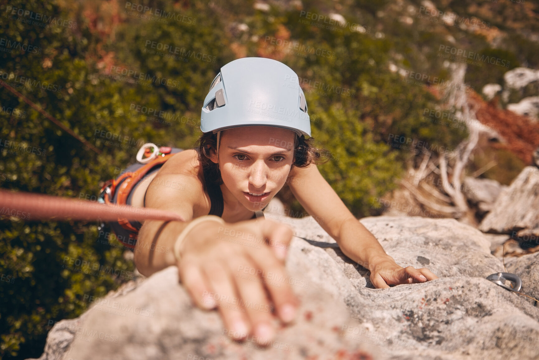 Buy stock photo Sports, exercise and mountain climbing with a woman climber scaling or abseiling a cliff. Fitness, workout and training with a young female on a climb in the forest or woods in nature from above