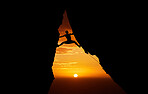 Mountain, sunset and fitness with the silhouette of a man climbing a cliff or rock outdoor in nature. Sun, horizon and sky with a climber outside for exercise, workout and training in the evening