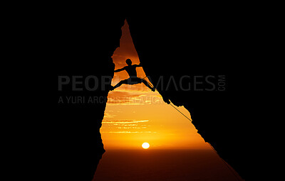 Buy stock photo Mountain, sunset and hiking with the silhouette of a man climbing a cliff or rock outdoor in nature. Sun, horizon and sky with a climber outside for exercise, workout and training in the evening