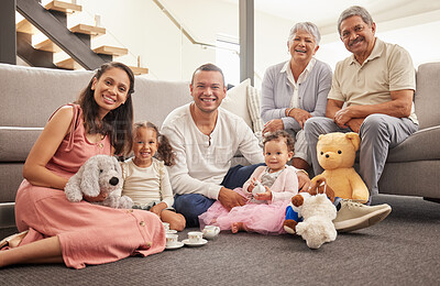 Buy stock photo Portrait of a happy family having a tea party in a living room together, smiling and relaxing on a floor. Cheerful grandparents enjoying the weekend with their grandkid, being playful and having fun 