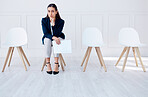 Portrait business woman waiting for an interview or stress applicant sitting alone. Sad or nervous corporate professional holding resume in line for job opening, vacancy and opportunity in office